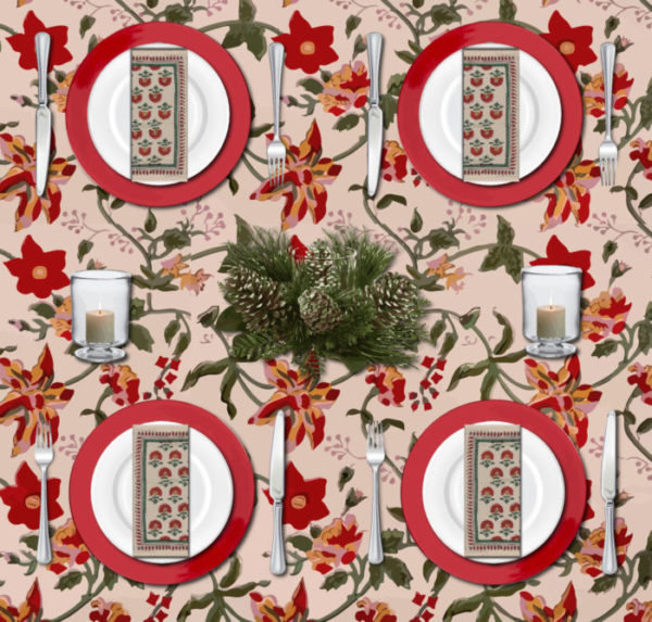 A colorful Christmas table set with a vintage Christmas tablecloth