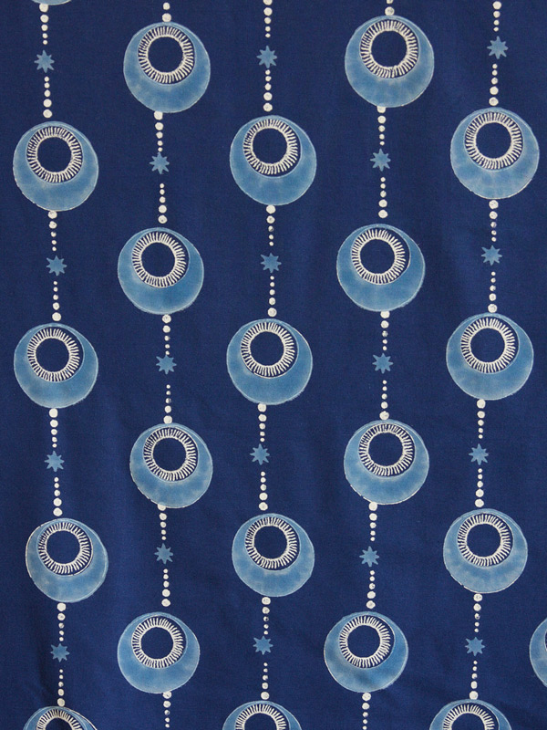 Picture of an Ottoman-inspired print with a white orb encased in a light blue one, repeated in rows and connected by pearls