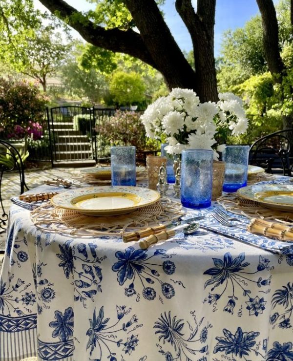 floral pattern blue and white tablecloth at an outdoor table setting