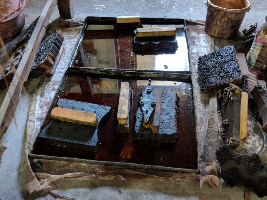 wood blocks used for block printing stand in trays of mustard oil to prevent warping