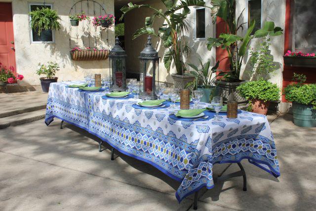 moroccan tablecloth, outdoor table setting with plants and lanterns set up for a party