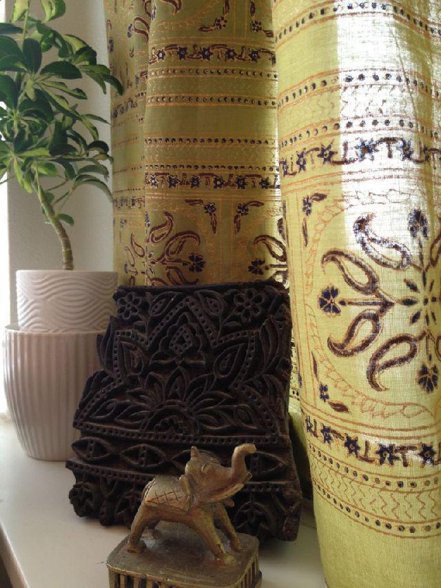 carved wood block, elephant statue, green curtain, all bohemian home decor