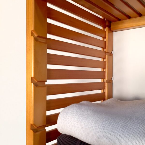 wooden ventilated shelf with folded linens