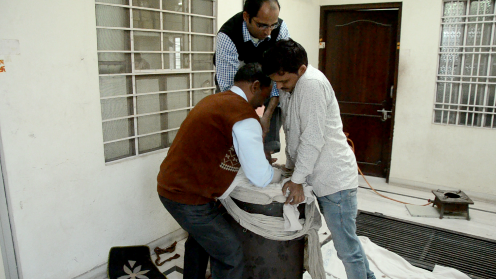 inserting linens into drum for steaming process