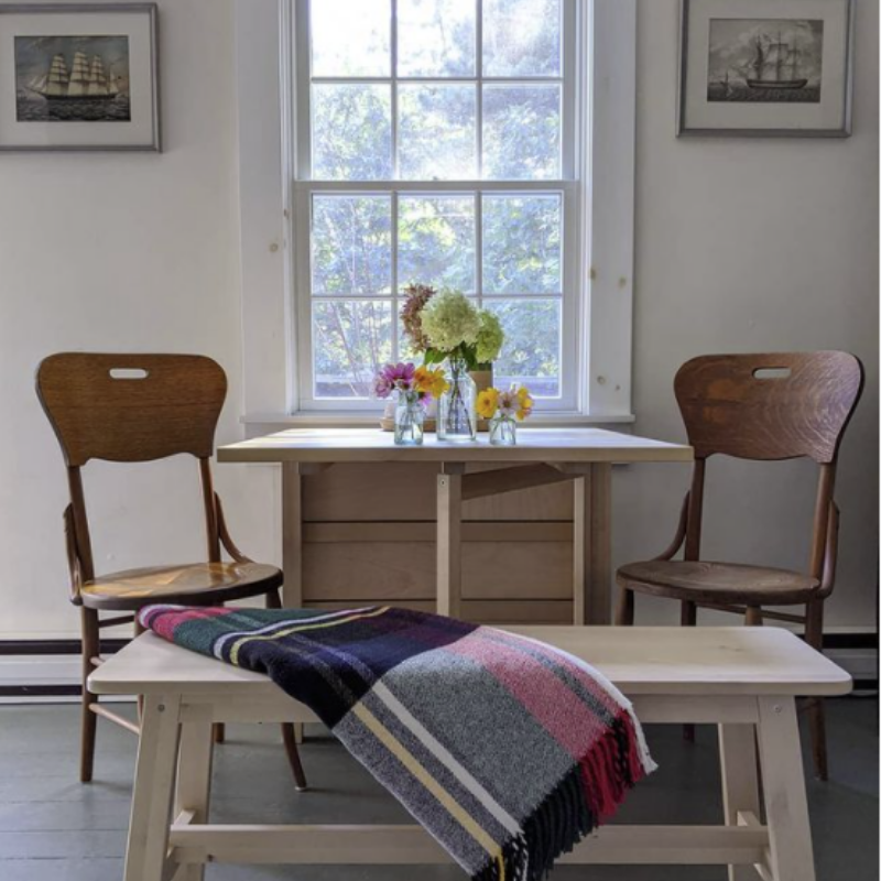 wooden kitchen table and bench in a coastal cottage