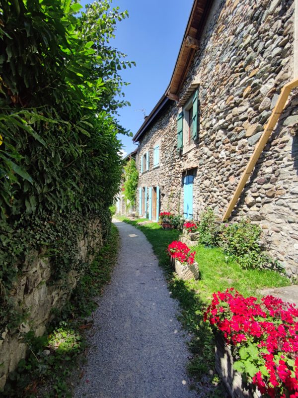 French cottage of stone and a floral pathway