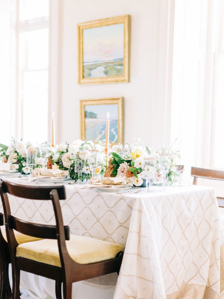 white and gold wedding tablecloth with candles and flowers
