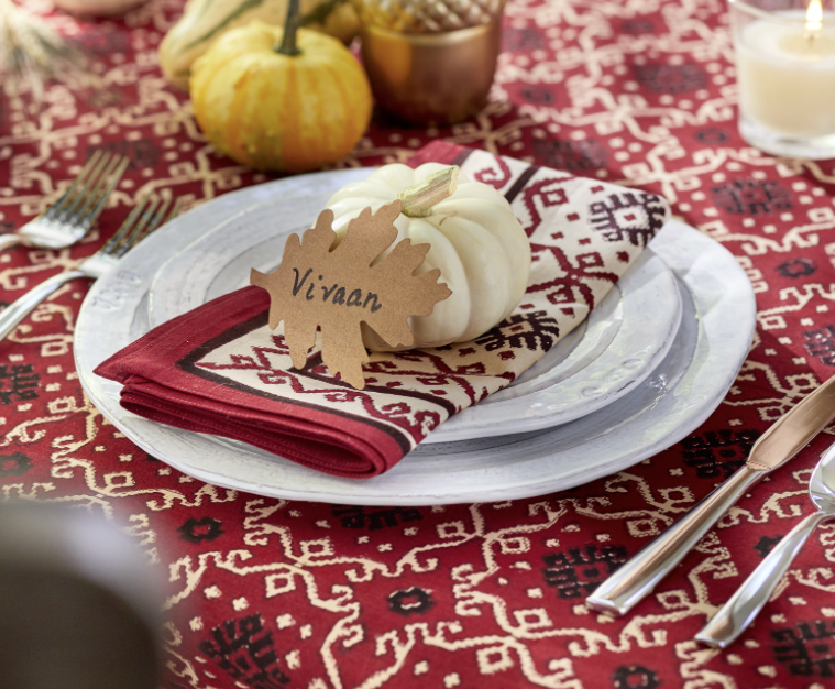 red Thanksgiving tablecloth with white pumpkin and namecard