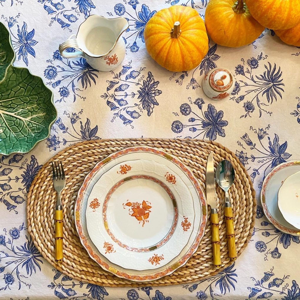 blue and white floral tablecloth and orange pumpkins