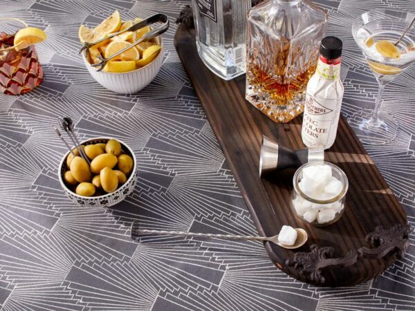 cocktail items on a grey tablecloth