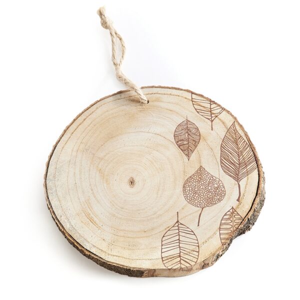 A raw, brown, wooden trivet with six, dark brown leaf sketches on its right plus a hanging hole and loop on the trivet’s top