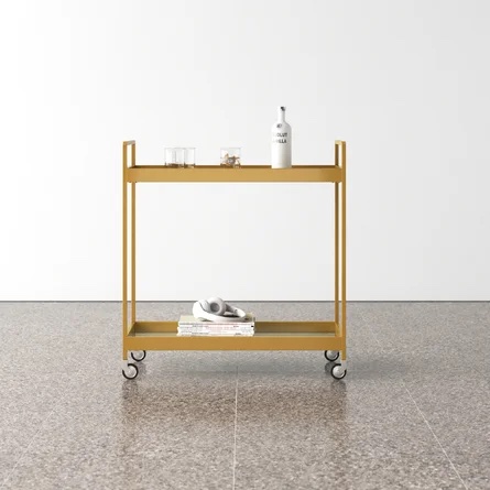 Brassy gold bar cart with a handful of items on top and below