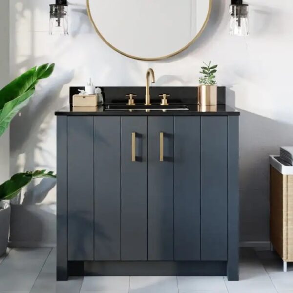 Dark gray and black bathroom cabinet with golden handles and faucet accessories