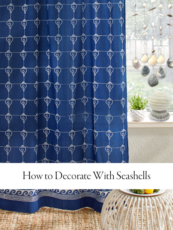 Photograph of a navy blue curtain with graphic conch shells and overlaid text "how to decorate with seashells"