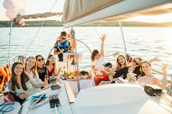 Photograph of a group of people on a boat smiling at the camera