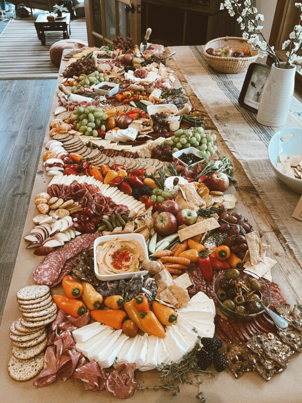 Photograph of a Thanksgiving charcuterie arrangement directly on a wooden table