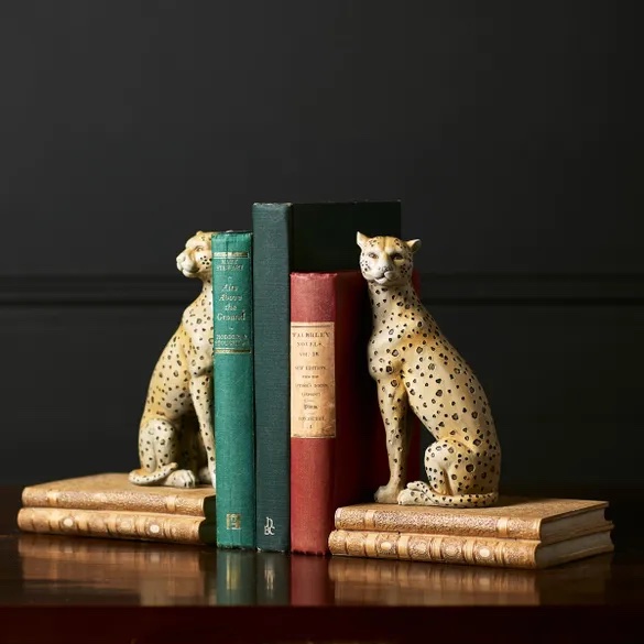 Pair of leopard bookends with three books in the middle