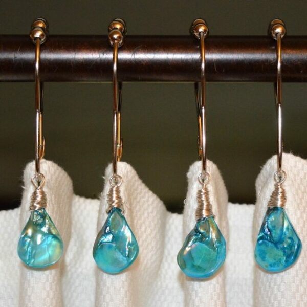 Photograph of sea shell shower curtain hooks for beach themed bathroom