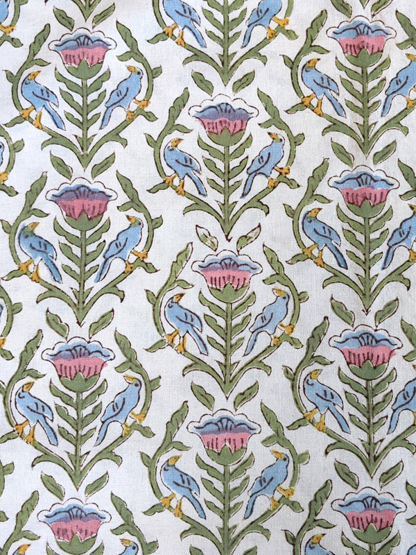 A pink, green, blue, and white fabric swatch that can be used with white decor