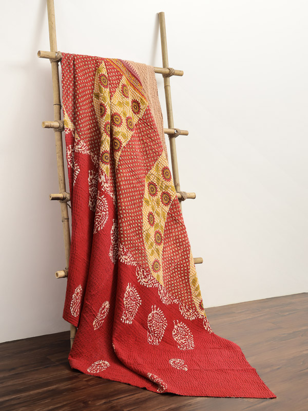 Red and orange vintage sari quilt for a boho bedroom.