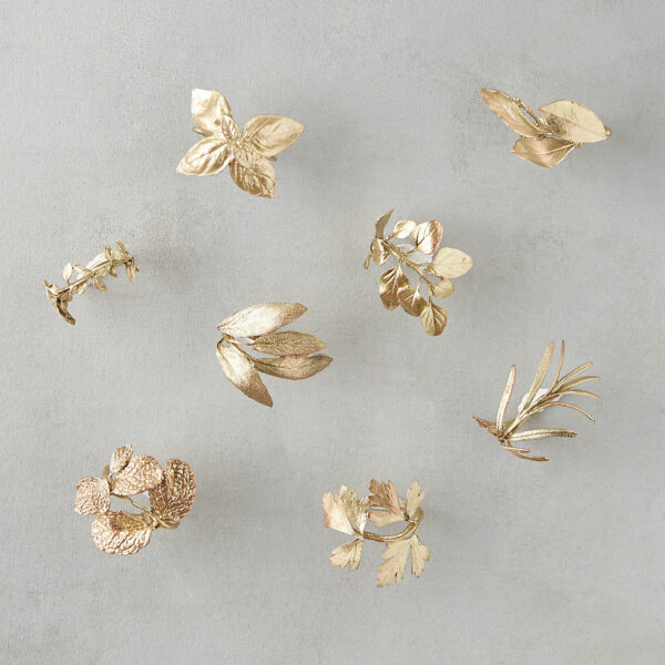 Example of gold napkin rings featuring a collection of rings made out of die-cast herbs