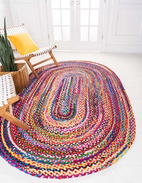 Photograph of a colorful rug in a neutral living room to demonstrate pops of color in a neutral common area