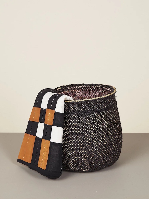 Photograph of a woven basket demonstrating the idea of how to refresh a guest room with a functional blanket basket