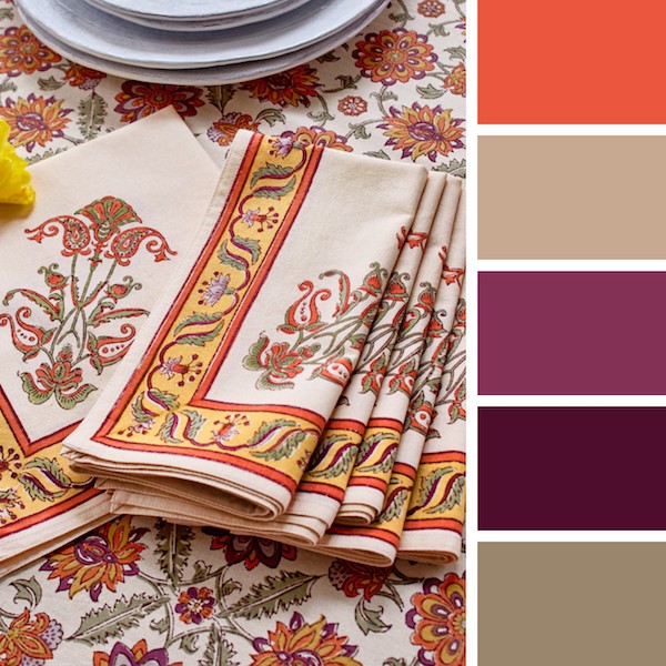 Photograph of an orange and plum floral table setting to demonstrate when is wedding season for the fall and how to decorate for it