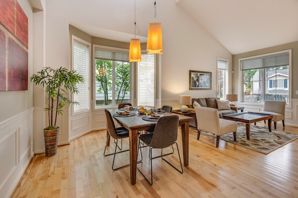 Photograph of a dining and living area showcasing the transitional interior design style