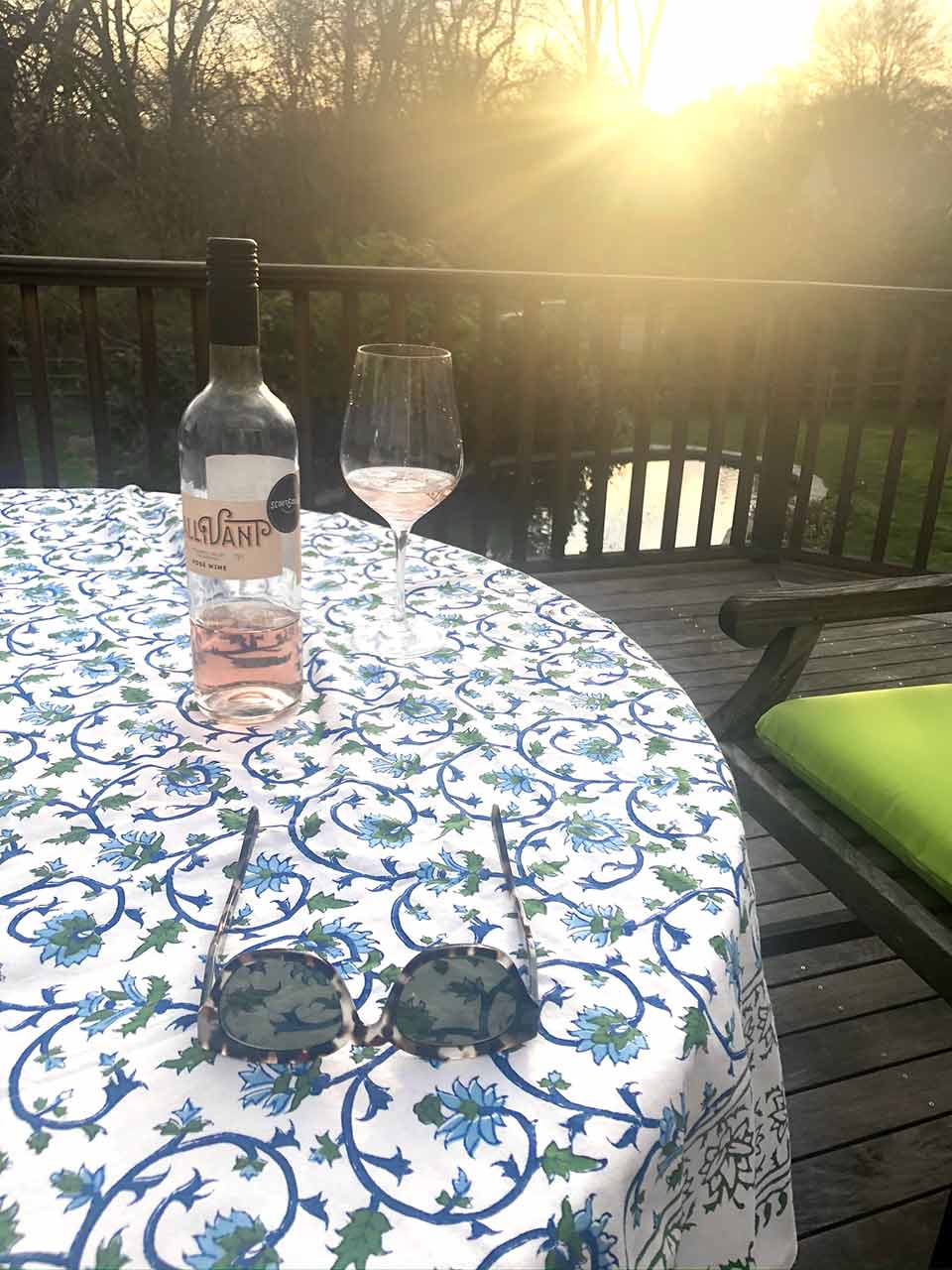 blue and white outdoor summer tablecloths on deck with wine